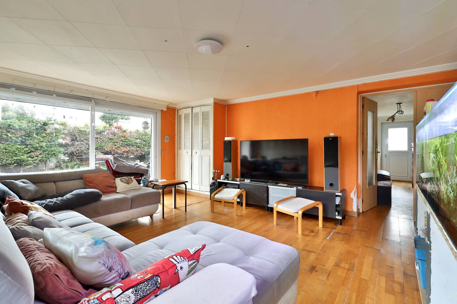 Séjour spacieux en RDC exposé nord/est ouvrant sur terrasse et jardin, grande baie vitrée et belle surface